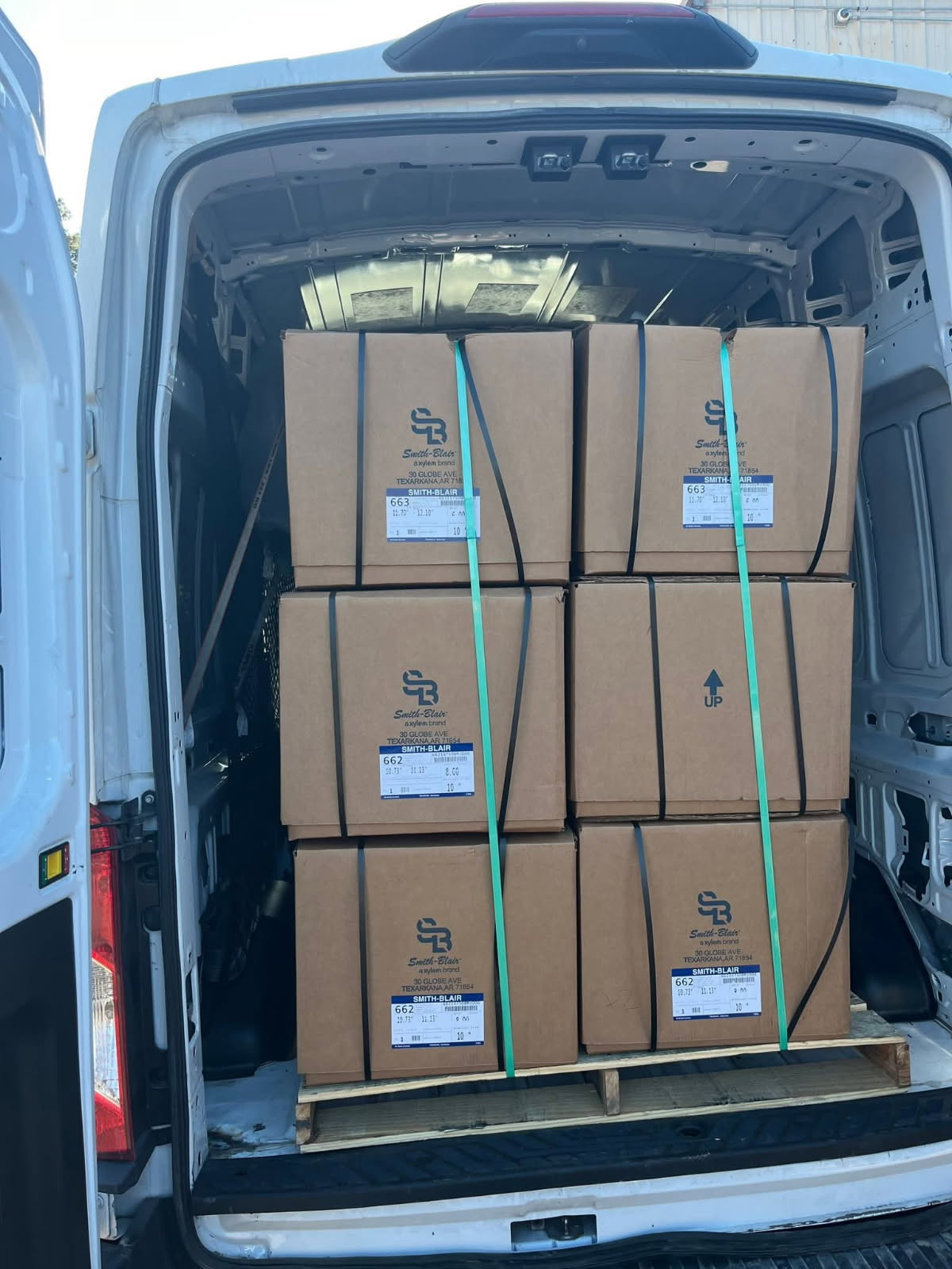 Palletized cargo securely strapped inside delivery van